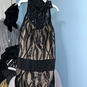 Black mesh detailed one piece dance costume with nude leotard underneath